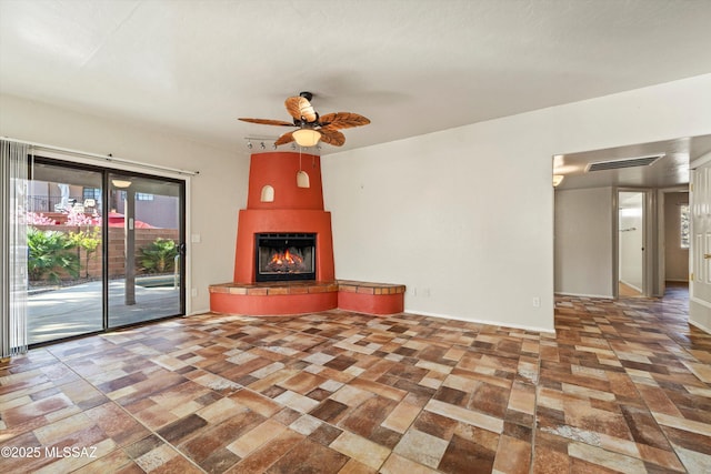 unfurnished living room with visible vents, a large fireplace, and a ceiling fan
