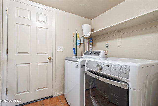 laundry area featuring independent washer and dryer, laundry area, and light tile patterned floors