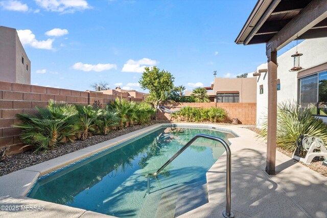 view of pool with a patio, a fenced in pool, and a fenced backyard