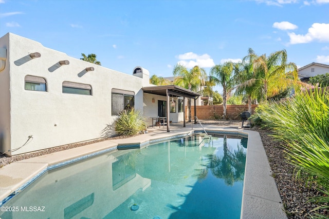 view of swimming pool with a fenced backyard, a fenced in pool, and a patio area