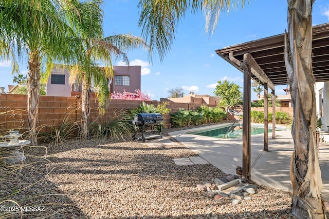 view of yard with a fenced backyard, a patio, and a fenced in pool