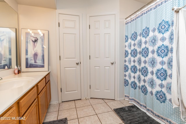 bathroom featuring tile patterned floors, vanity, baseboards, and a shower with curtain