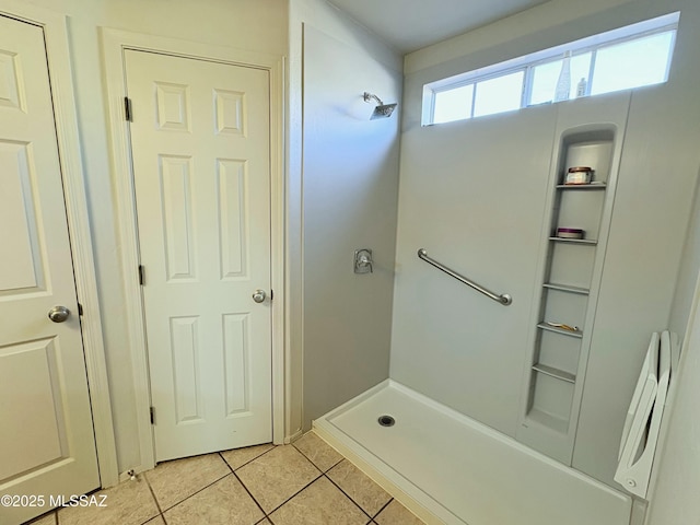 full bathroom featuring tile patterned floors and walk in shower