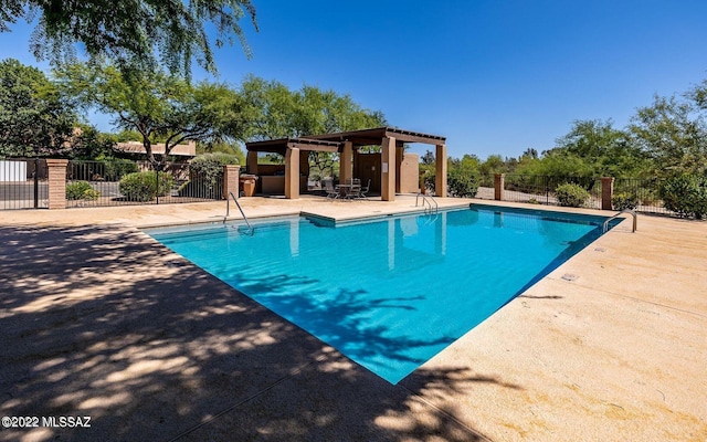 pool featuring a patio and fence