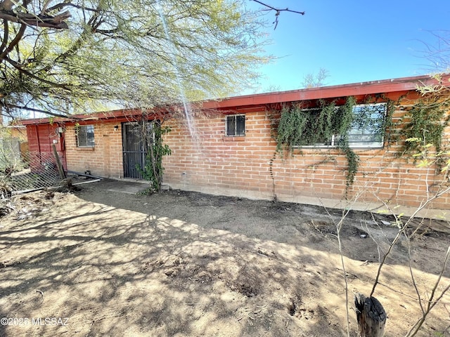 exterior space featuring brick siding