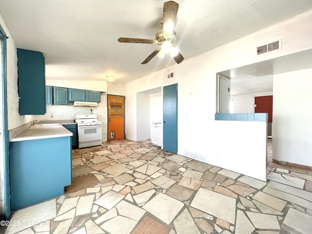 kitchen with white range with gas stovetop, light countertops, visible vents, and blue cabinets