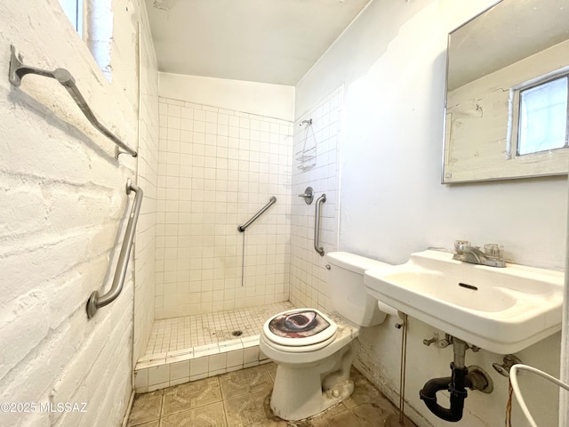 full bath with a sink, toilet, tile patterned flooring, and a shower stall