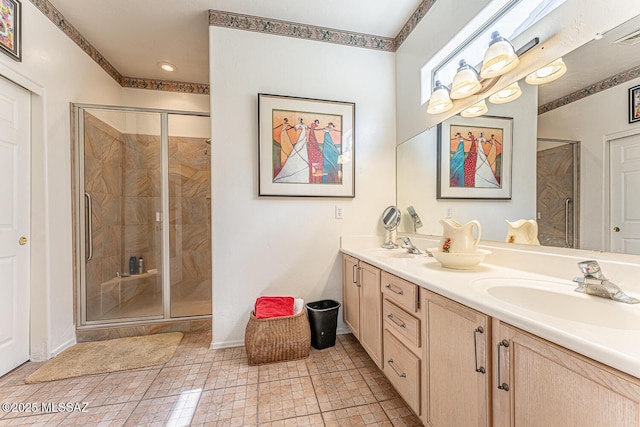 bathroom featuring double vanity, a sink, and a stall shower