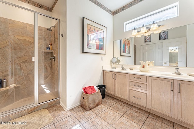 bathroom with ornamental molding, baseboards, a sink, a stall shower, and double vanity