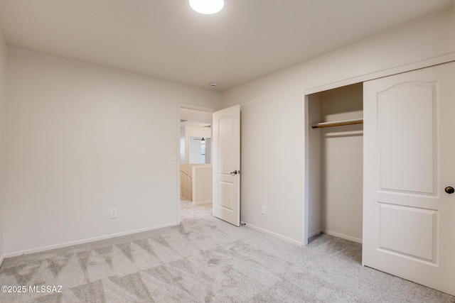 unfurnished bedroom with a closet, baseboards, and carpet