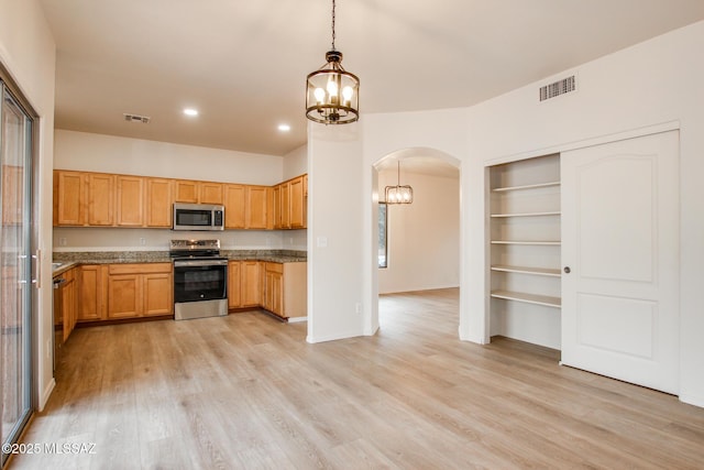 kitchen featuring visible vents, a notable chandelier, light wood-style flooring, stainless steel appliances, and arched walkways