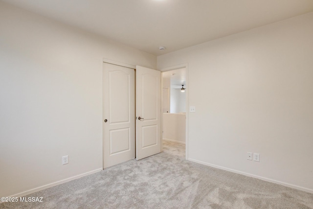 empty room featuring carpet flooring and baseboards