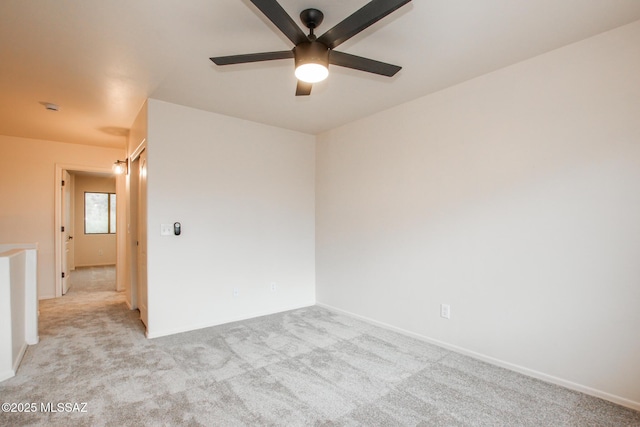 unfurnished room with a ceiling fan and light colored carpet