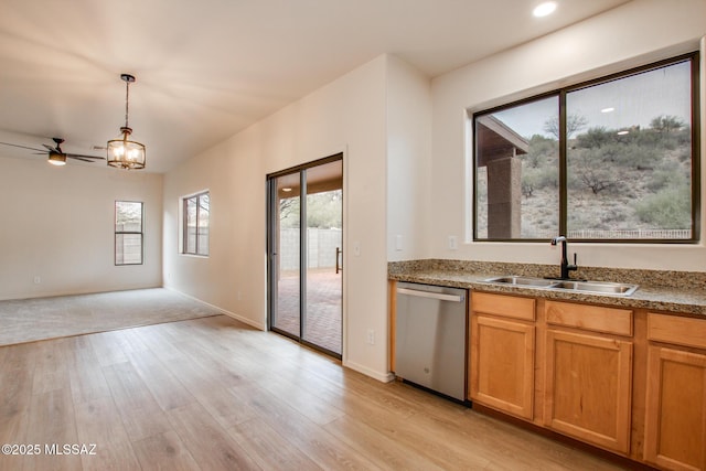 kitchen with light wood-style flooring, ceiling fan with notable chandelier, a sink, stainless steel dishwasher, and hanging light fixtures