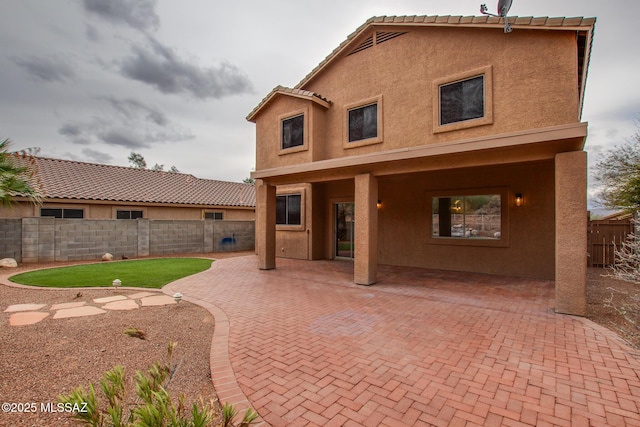 back of property featuring a patio, a fenced backyard, and stucco siding