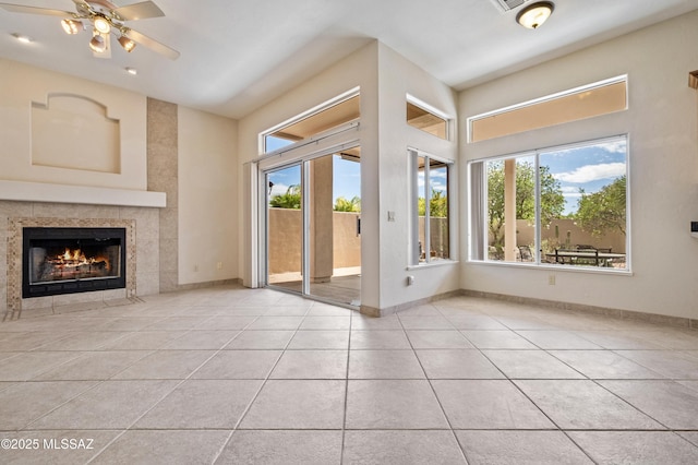 420 E Deers Rest Pl, Tucson, AZ 85704 - unfurnished living room featuring baseboards, tile patterned floors, ceiling fan, and a tile fireplace