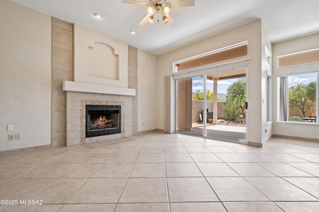 420 E Deers Rest Pl, Tucson, AZ 85704 - unfurnished living room featuring light tile patterned flooring, baseboards, a fireplace, and a ceiling fan