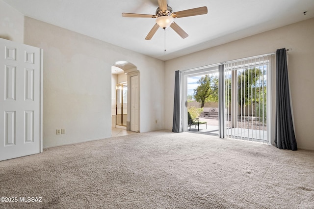 420 E Deers Rest Pl, Tucson, AZ 85704 - spare room with arched walkways, carpet, and ceiling fan