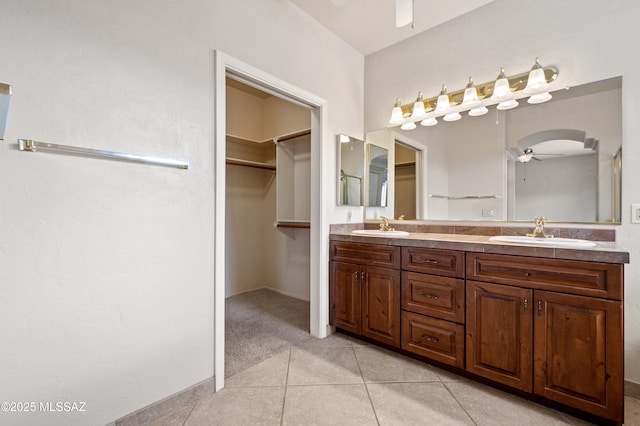 420 E Deers Rest Pl, Tucson, AZ 85704 - full bath featuring double vanity, tile patterned flooring, a sink, and a ceiling fan