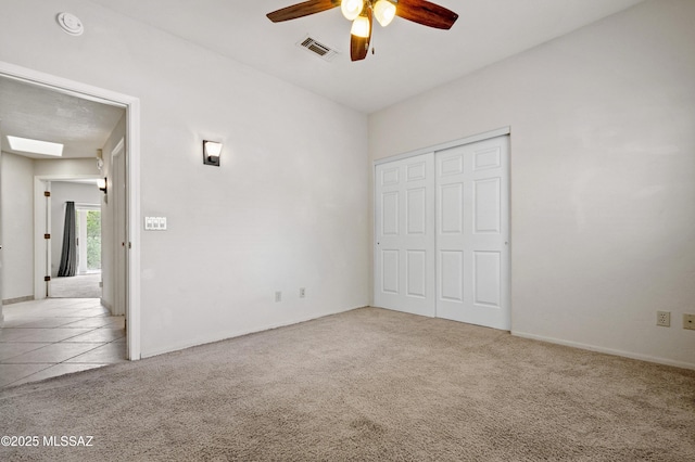 420 E Deers Rest Pl, Tucson, AZ 85704 - unfurnished bedroom with a closet, visible vents, ceiling fan, carpet floors, and tile patterned flooring