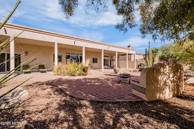 420 E Deers Rest Pl, Tucson, AZ 85704 - back of property featuring a fire pit, stucco siding, fence, and a patio area