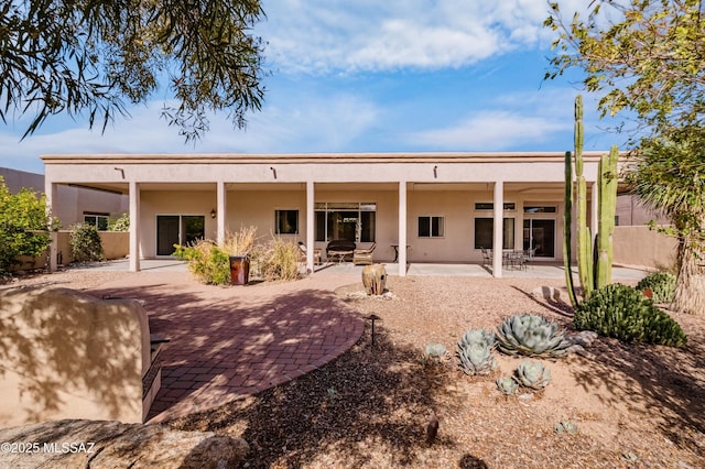 420 E Deers Rest Pl, Tucson, AZ 85704 - rear view of house featuring stucco siding, fence, and a patio area