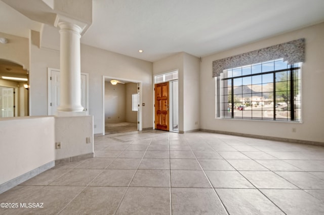 420 E Deers Rest Pl, Tucson, AZ 85704 - empty room featuring decorative columns, light tile patterned flooring, and baseboards