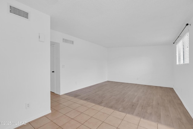 spare room featuring visible vents and light wood-style flooring