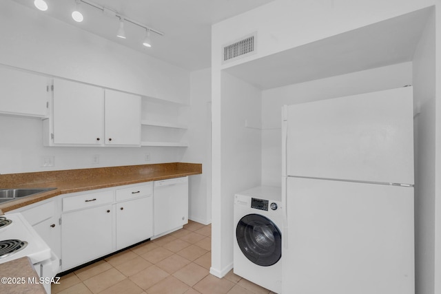 laundry area featuring laundry area, light tile patterned floors, rail lighting, washer / clothes dryer, and visible vents