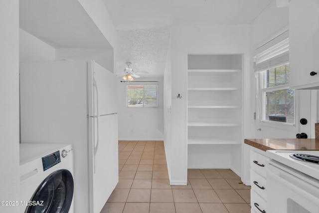 laundry area with washer / clothes dryer, a textured ceiling, a ceiling fan, light tile patterned flooring, and laundry area
