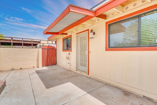 view of patio with fence and a gate