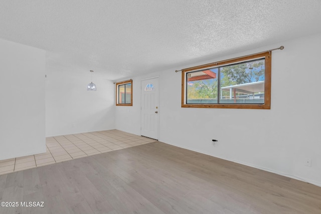 interior space featuring a textured ceiling and wood finished floors