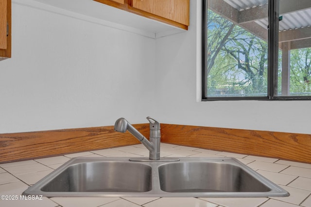 interior details with a sink and tile counters