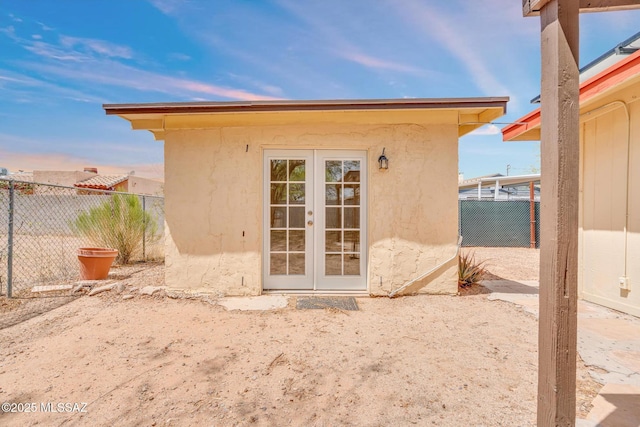 exterior space featuring french doors and fence