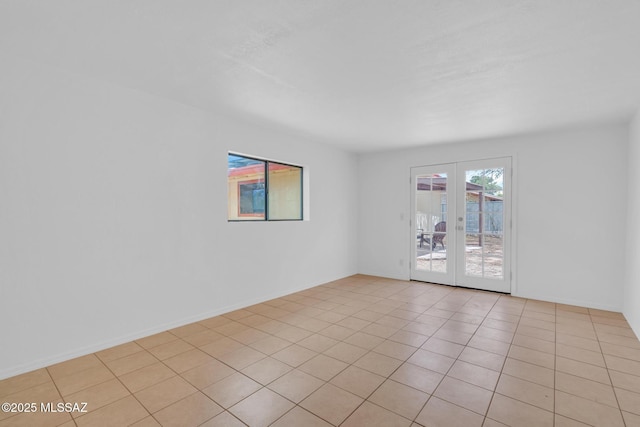 unfurnished room with french doors and light tile patterned floors