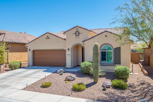 6949 W Tanner Trl, Marana, AZ 85658 - mediterranean / spanish house featuring stucco siding, a tile roof, concrete driveway, and an attached garage