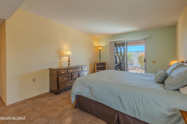 tiled bedroom with access to outside and a textured ceiling