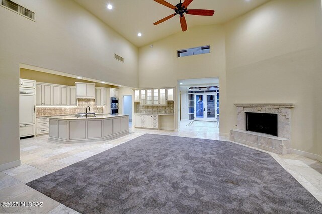 7222 E Desert Moon Loop, Tucson, AZ 85750 - unfurnished living room featuring a sink, ceiling fan, recessed lighting, a tile fireplace, and baseboards