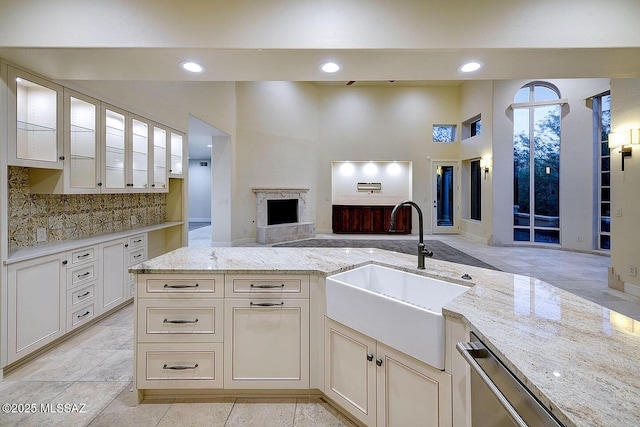 7222 E Desert Moon Loop, Tucson, AZ 85750 - kitchen with a sink, stainless steel dishwasher, light stone countertops, open floor plan, and backsplash