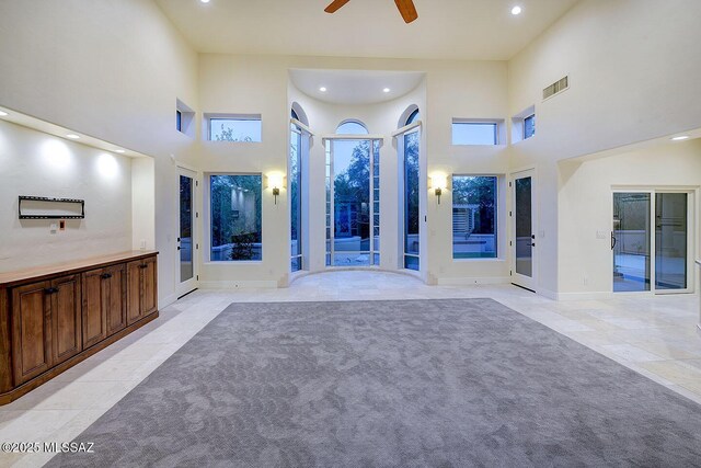 7222 E Desert Moon Loop, Tucson, AZ 85750 - unfurnished living room featuring light tile patterned flooring, ceiling fan, a towering ceiling, recessed lighting, and baseboards