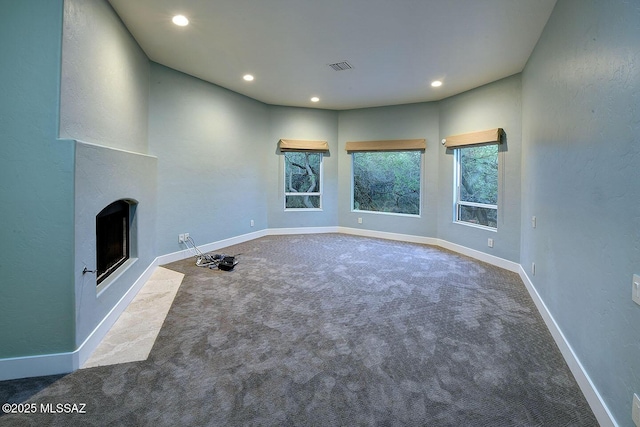 7222 E Desert Moon Loop, Tucson, AZ 85750 - unfurnished living room featuring carpet flooring, a fireplace with flush hearth, recessed lighting, and baseboards