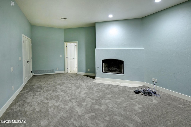 7222 E Desert Moon Loop, Tucson, AZ 85750 - unfurnished living room featuring carpet, a fireplace with flush hearth, baseboards, and recessed lighting
