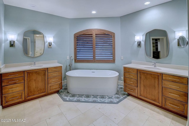 7222 E Desert Moon Loop, Tucson, AZ 85750 - bathroom featuring a freestanding tub, two vanities, and recessed lighting