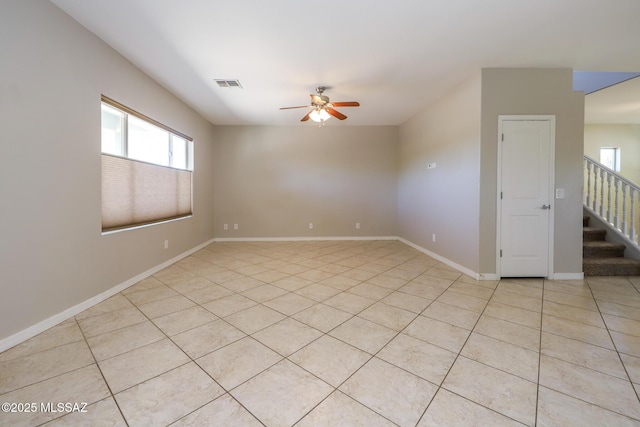 unfurnished room with plenty of natural light, visible vents, ceiling fan, and light tile patterned floors