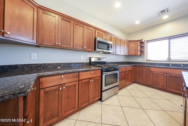 kitchen featuring a sink, visible vents, appliances with stainless steel finishes, open shelves, and light tile patterned floors