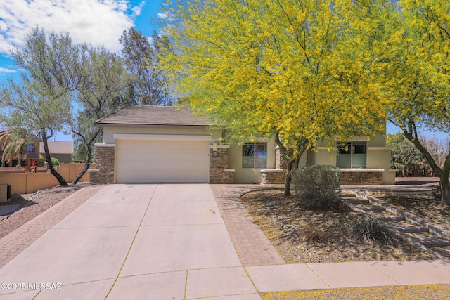 obstructed view of property featuring an attached garage, driveway, stone siding, and stucco siding