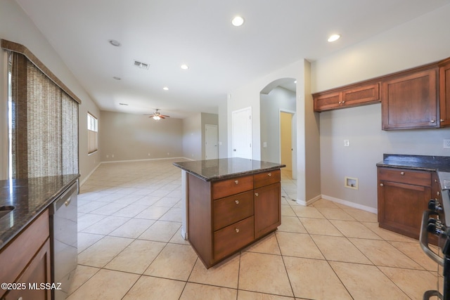 kitchen with visible vents, a ceiling fan, stainless steel dishwasher, arched walkways, and light tile patterned flooring