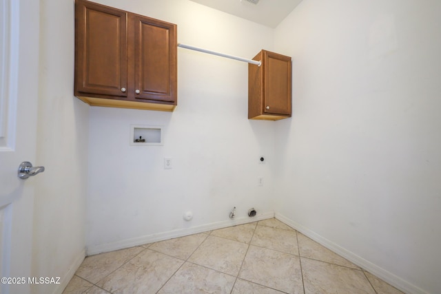 clothes washing area featuring hookup for an electric dryer, baseboards, hookup for a washing machine, hookup for a gas dryer, and cabinet space