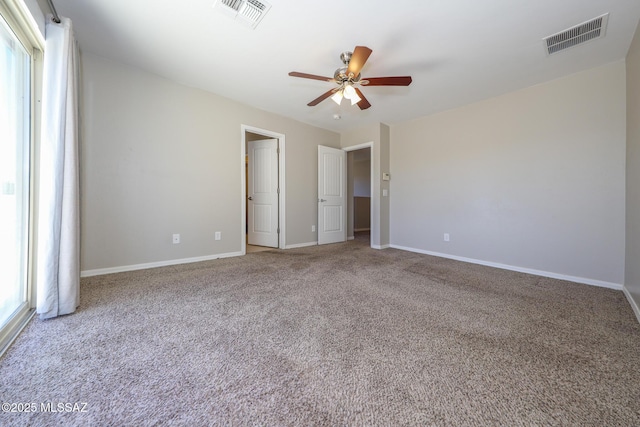 unfurnished bedroom with carpet, visible vents, a ceiling fan, and baseboards
