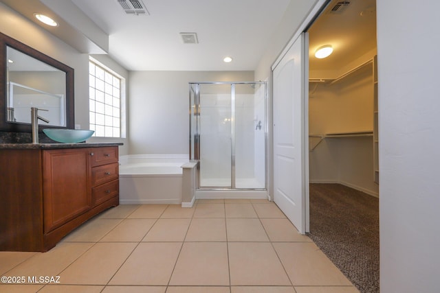 bathroom featuring vanity, tile patterned floors, visible vents, and a stall shower